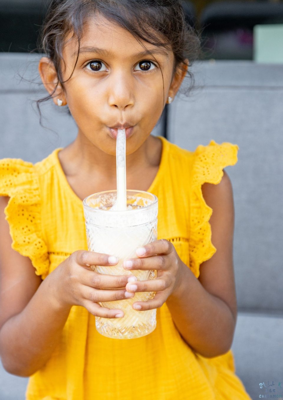 Girl drinking tropical orange smoothie